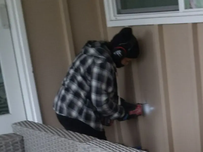 Professional electrician installing an exterior outlet in Apison