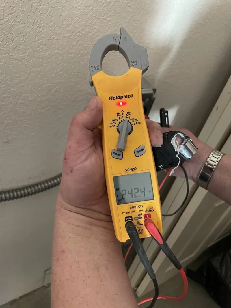 Voltage testing with clamp meter during Outlet Installation in Apison